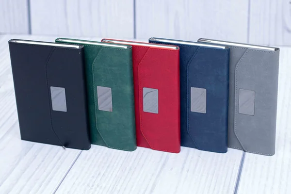 E545 executive notebooks with a window plate, in black, green, red, navy and grey